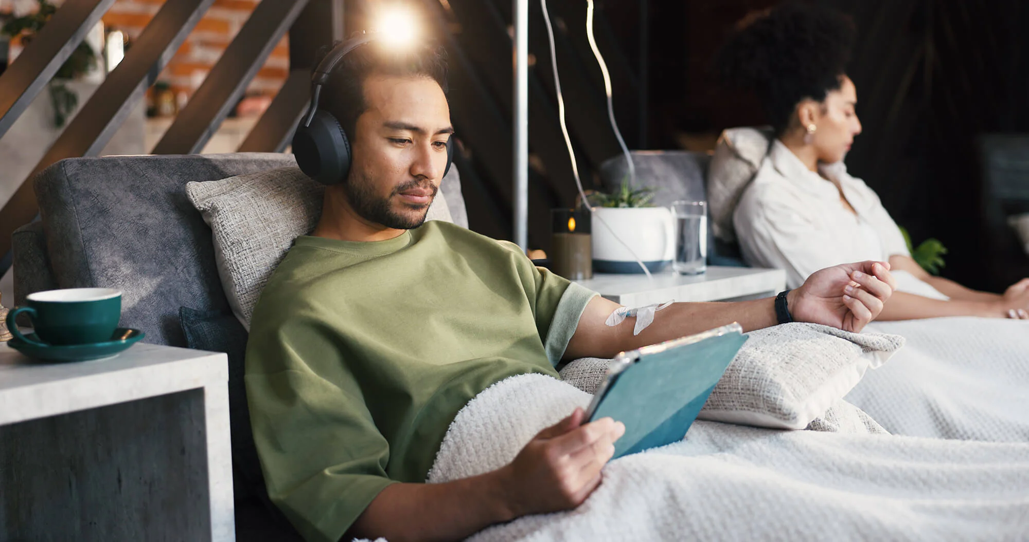 Male on iPad while getting IV Therapy