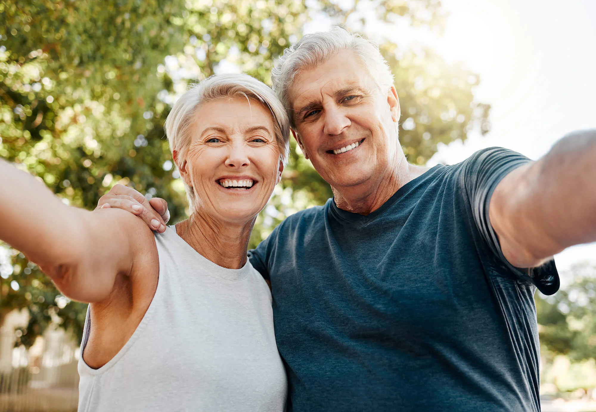 Mature couple hugging and smiling while outdoors